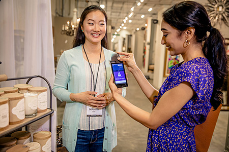 Cashier accepts payment from a customer in retail store