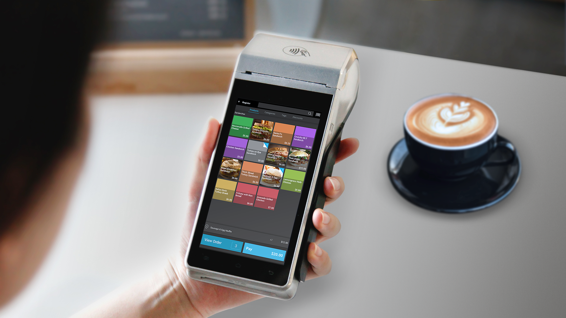 Person holding credit card terminal